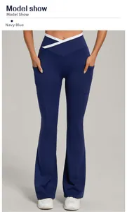 Detail of high waist yoga flare pants with navy blue fabric and white V-cross waistband