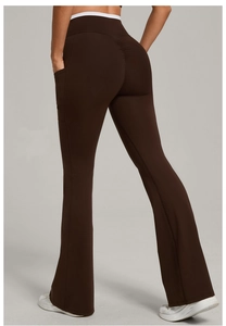Detail view of brown flare yoga pants with white waist trim and side phone pocket