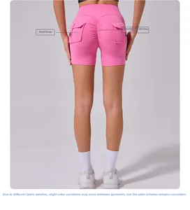 Detail view of hot pink yoga shorts with buttoned side pockets and scrunched bum lifting