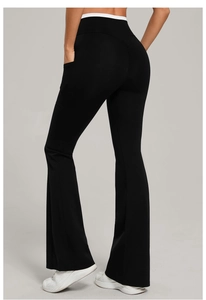 Detail view of high waisted yoga flare pants with side pockets and white contrast waist