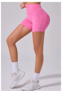 Detail showing the side pocket with button on high waist rose pink yoga shorts