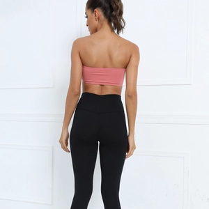 Rear view of pink bandeau sports bra and black high-waisted shaping leggings for yoga