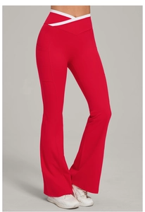 Detail of red flared yoga pants with white cross-waist design and side pocket