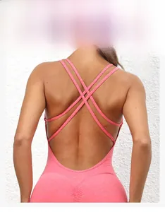 Detailed back view of pink fitness jumpsuit featuring a cross double strap design
