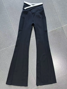 Detailed view of black yoga flare pants with contrast V-shaped cross waist and side pockets