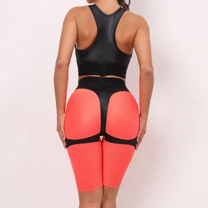 Rear view of backless fitness set featuring orange honeycomb shorts with black strap details