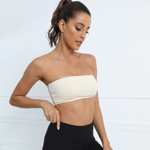 Detail view of the strapless ribbed cream yoga top with a seamless minimalist design
