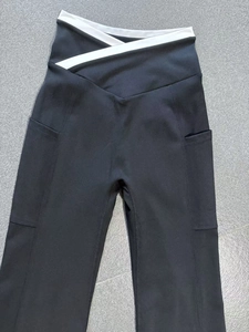 Detail of high waist yoga flare pants featuring contrast V-cross waist and side pockets