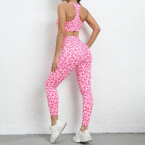 Detail view of pink leopard print high-waisted yoga leggings with peach butt-lift design