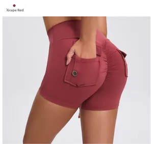 Detail of scrunch butt seam and side button pocket on wine red high waist yoga shorts