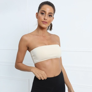 Detail of cream white strapless tube top yoga bra featuring breathable elastic fabric