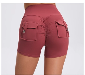 Detail of high waist dark red scrunch butt yoga shorts with functional side cargo pockets