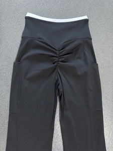 Detail view of high waist yoga flare pants featuring scrunch butt and side pockets