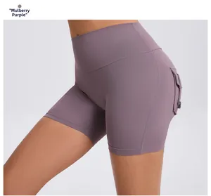 Detail of high waisted yoga shorts in mulberry purple with cargo pockets and elastic fit