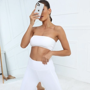 Detailed view of white strapless sports bra and high waist yoga leggings set in matte fabric