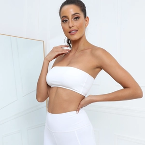 Minimalist white yoga tube top and high waist leggings set shown in a clean indoor setting