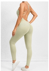 Detail of light green ruched back yoga bodysuit showing cross straps and butt lifting seam