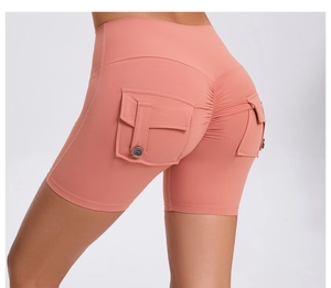 Detail view of coral pink high waisted scrunch butt yoga shorts with cargo side pockets