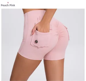 Close-up of high waist peach pink yoga shorts with side pockets and scrunch butt detail