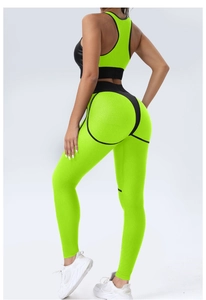 Detail of high-waisted yoga pants with black contour seams and green honeycomb texture fabric