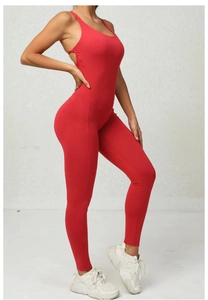 Detailed close-up of red ribbed yoga jumpsuit featuring thin straps and backless design