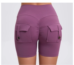 Detail of high waist scrunch butt gym shorts in magenta with cargo button pockets