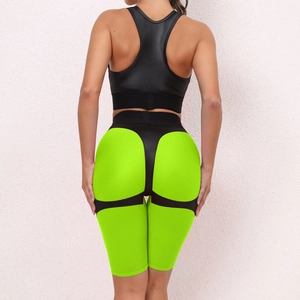 Detail of racerback sports bra and honeycomb texture lifting shorts in neon green