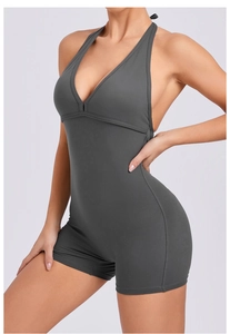 Detail of high-elasticity charcoal gray halter jumpsuit with deep V-neck and open back