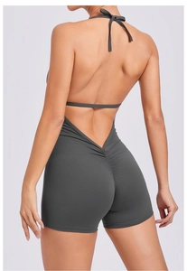 Detail of grey backless yoga bodysuit featuring scrunch butt design and halter neck style