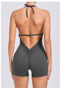 Back view of a deep grey halter yoga bodysuit with open back and scrunch butt detail