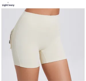 Detail view of light ivory high waisted yoga shorts with functional side pockets