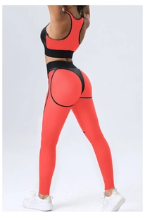 Detail view of red and black mesh sports bra and high waist leggings with honeycomb texture