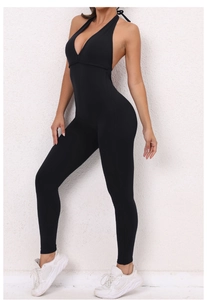 Close-up of black backless halter yoga jumpsuit with deep V-neck and scrunch butt detail