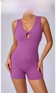Close-up of magenta sports romper with deep V-neck and twist front hollow design