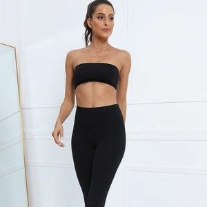 Close-up of black strapless sports bra and high-waisted leggings set in high-stretch fabric