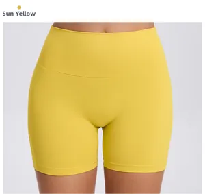 Detail of high waist yoga shorts in Sun Yellow with moisture wicking stretch fabric