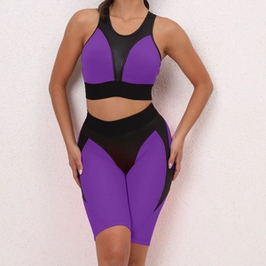 Detail view of purple and black yoga set with breathable mesh fabric and ergonomic seams