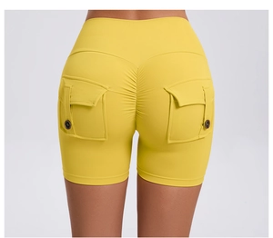 Rear view of high-waist yellow yoga shorts featuring cargo pockets and ruched lifting detail