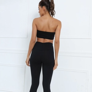 Close-up of seamless black yoga set featuring a tube top and high waist leggings