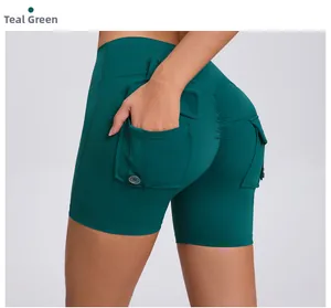 Detail view of lake green scrunch butt yoga shorts with side cargo button pockets