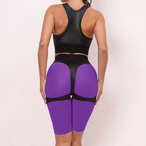 Detail of high-waist yoga shorts with purple honeycomb texture and cut-out cross strap design