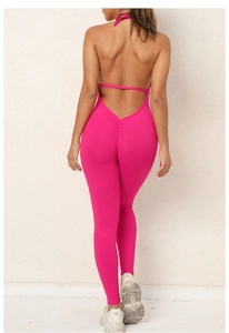 Detail of cross-back straps and scrunch butt design on hot pink yoga jumpsuit