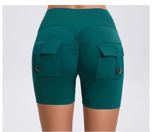 Detail of scrunch butt yoga shorts in dark green with cargo pockets and buttons
