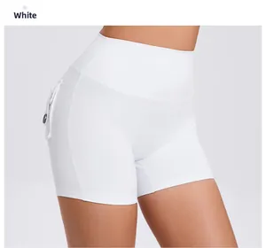 Detail of high waist white yoga shorts with a button pocket and butt lifting design