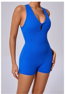 Detail of royal blue yoga romper featuring a V-neckline with twist-knot hollow design
