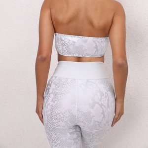 Close-up back view of white snakeskin printed strapless sports bra and yoga leggings