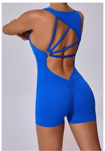 Detail of blue scrunch butt yoga jumpsuit featuring cross straps and metal ring back