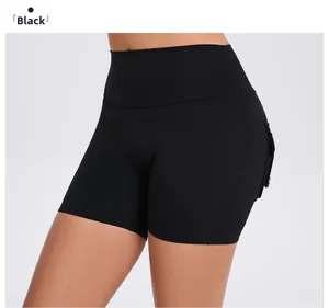 Detail shot of high waisted black yoga shorts with side cargo pockets and butt lift effect