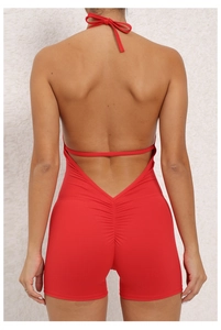Back view of red halter neck jumpsuit featuring an open back and ruched peach butt detail