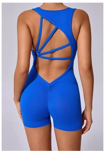 Detail view of Klein blue yoga jumpsuit featuring back cutout and crisscross strap design